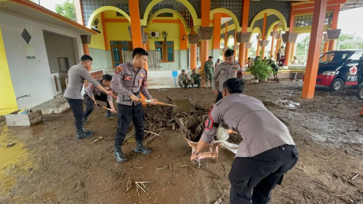Sinergitas Polisi Bersama TNI dan Warga Bersihkan Lumpur Pasca Banjir di Situbondo